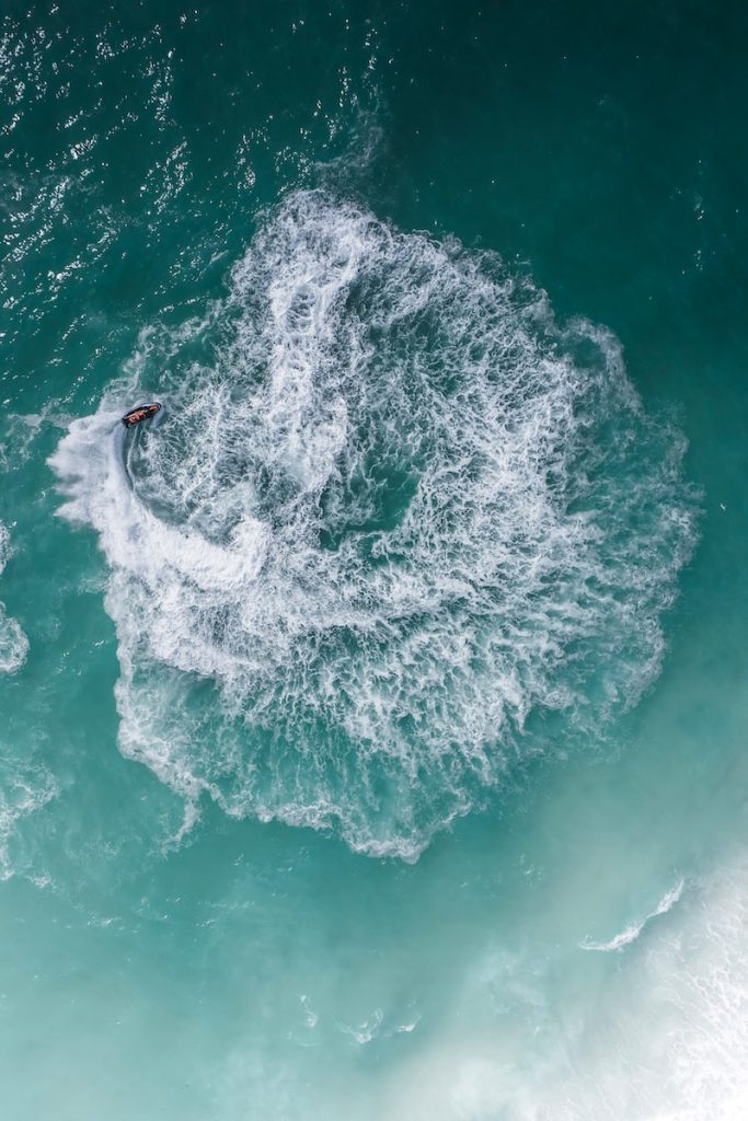 a person riding a surfboard on a wave in the ocean